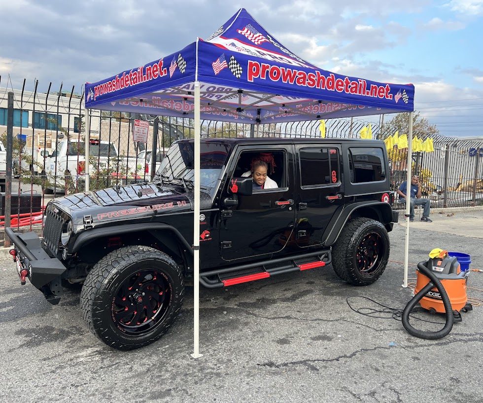 Customer waiting in a black Jeep Wrangler during a hand wash at Pro Wash Detail in Northeast Washington DC