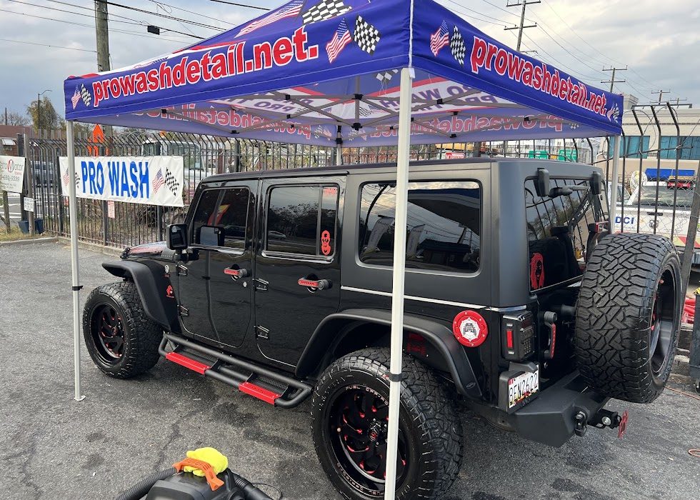 Black Jeep Wrangler with red trim after an exterior hand wash at Pro Wash Detail on Kenilworth Ave NE